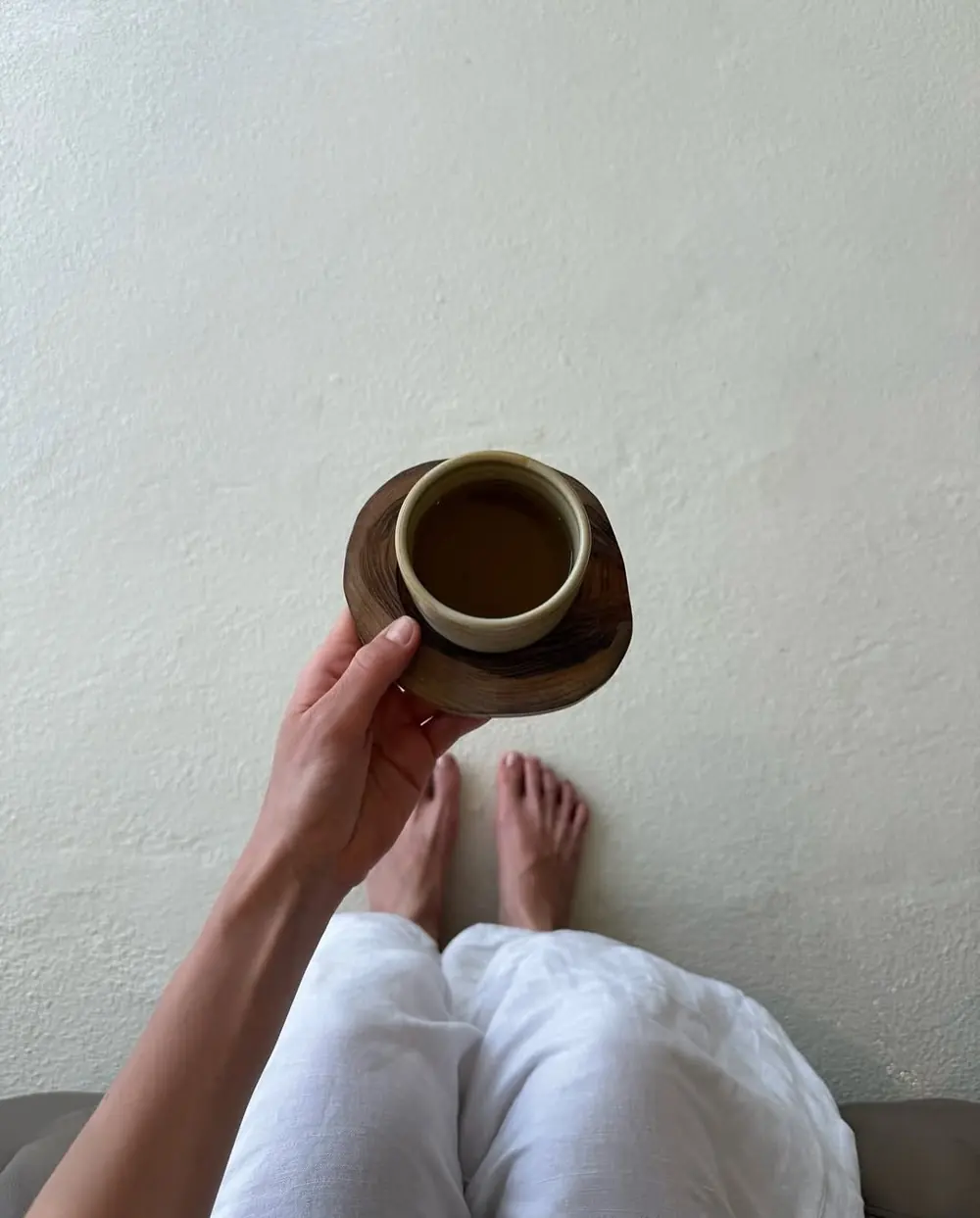 Hands holding a cup of tea