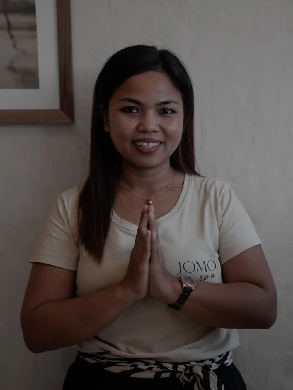 A JOMO therapist greeting with hands together
